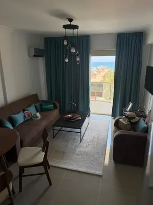 a living room with a couch and a table at Two Bedrooms LongBeach SeaView Escape in Paralimni