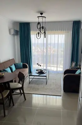 a living room with a couch and a table at Two Bedrooms LongBeach SeaView Escape in Paralimni