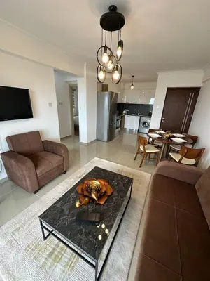 a living room with a couch and a table at Two Bedrooms LongBeach SeaView Escape in Paralimni