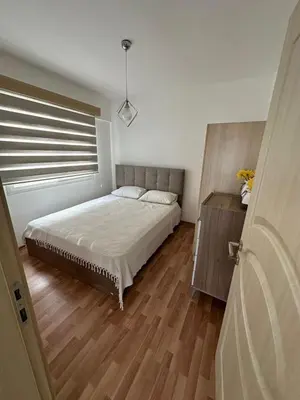 a bedroom with a large bed and a window at Two Bedrooms LongBeach SeaView Escape in Paralimni