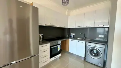 a kitchen with a stainless steel refrigerator and a dishwasher at Two Bedrooms LongBeach SeaView Escape in Paralimni