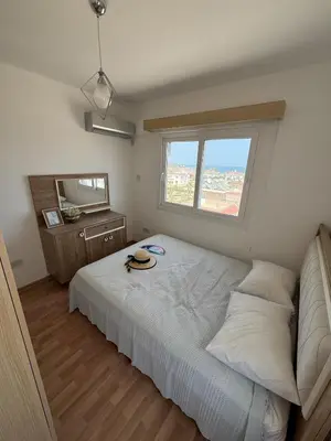 a bedroom with a bed and a window and a mirror at Two Bedrooms LongBeach SeaView Escape in Paralimni