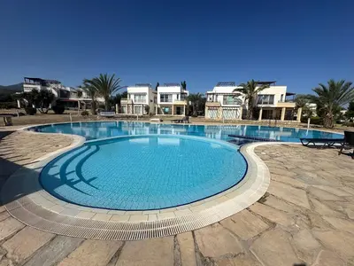a large swimming pool in the middle of a patio at Esentepe Turtle Bay Village - The Boho Breeze Holiday Home in Aglantzia