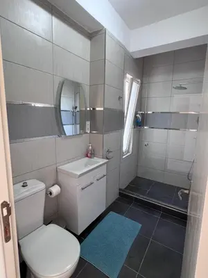a bathroom with a toilet and a sink and a mirror at Esentepe Turtle Bay Village - The Boho Breeze Holiday Home in Aglantzia
