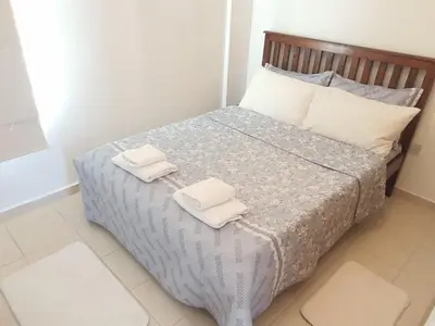 a bedroom with a bed with two towels on it at Esentepe Turtle Bay Village - The Boho Breeze Holiday Home in Aglantzia