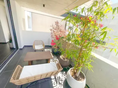 a room with a table and chairs and plants at Bridge House 301-3BR Penthouse in Limassol