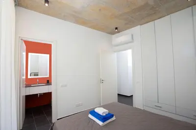 a bedroom with a bed with a mirror and a sink at Bridge House 301-3BR Penthouse in Limassol
