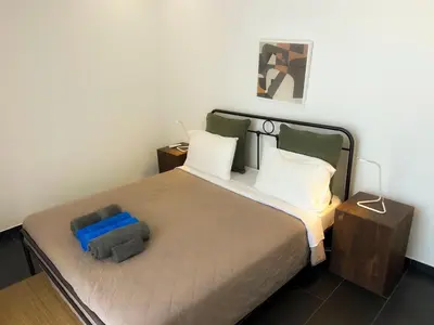 a bedroom with a large bed with two night stands at Bridge House 301-3BR Penthouse in Limassol