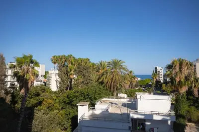 a view from the roof of a house with palm trees and the ocean at Bridge House 301-3BR Penthouse in Limassol