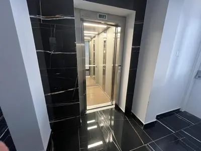 a hallway with a walk in shower and a mirror at One Bedroom Penthouse Flat in Larnaka