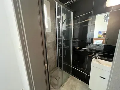 a bathroom with a shower and a sink at One Bedroom Penthouse Flat in Larnaka