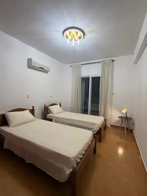 a room with two beds and a chandelier at Margarita Luxury 3 Bed & Pool in Dherinia