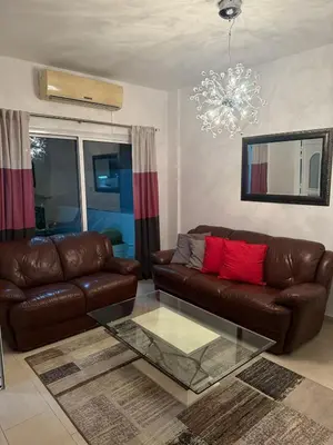 a living room with a leather couch and a glass table at Margarita Luxury 3 Bed & Pool in Dherinia