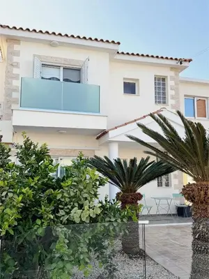 a house with palm trees in front of it at Margarita Luxury 3 Bed & Pool in Dherinia