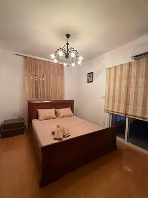 a bedroom with a large bed with a chandelier at Margarita Luxury 3 Bed & Pool in Dherinia