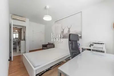 a white room with a bed and a desk at Napa blue Nissi beach apartments in Ayia Napa