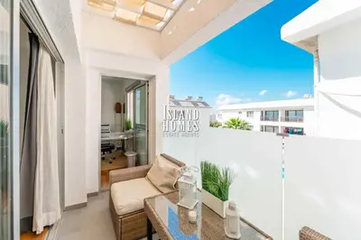 a room with a balcony with a table and a couch at Napa blue Nissi beach apartments in Ayia Napa