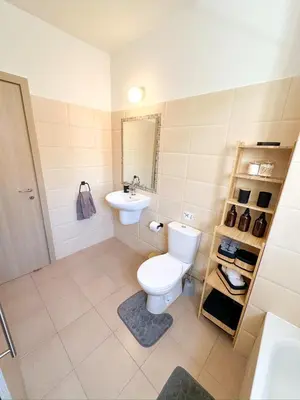 a bathroom with a toilet and a sink at Sunny Pyla Escape with Pool, Tennis & Fast Wi-Fi in Pyla