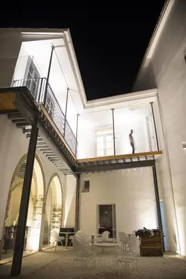 a person standing on a balcony of a building at Lokàl Boutique Hotel in Larnaka