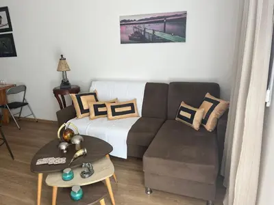 a living room with a couch and a table at Panos salt lake apartment in Aglantzia