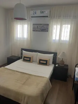 a bedroom with a large bed with two pillows at Panos salt lake apartment in Aglantzia
