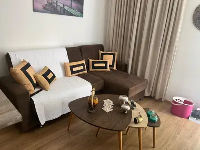 a living room with a couch and a table at Panos salt lake apartment in Aglantzia