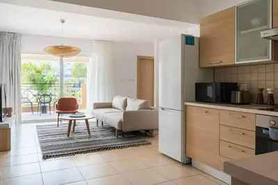 a kitchen and living room with a couch and a table at 2BR Apartment with Amazing View and Pool in Kiti in Kiti