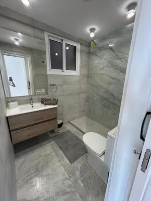 a bathroom with a toilet and a sink at Modern 3BR Family Apartment in Quiet Drosia with Balcony in Larnaka