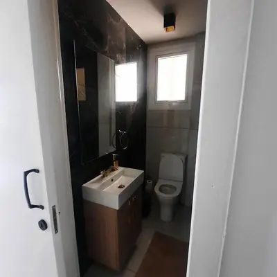 a bathroom with a sink and a toilet at Modern 3BR Family Apartment in Quiet Drosia with Balcony in Larnaka