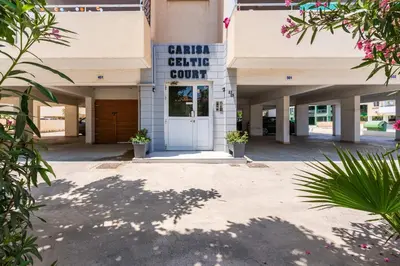 a building with a sign that reads cancer center court at Stylish 2BR Apartment with Rooftop Pool in Mackenzie in Larnaka