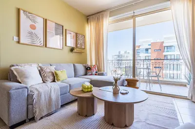 a living room with a couch and a table at Mystique 1-Bedroom Apartment in Larnaka