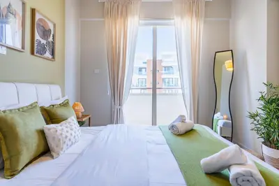 a bedroom with a bed and a large window at Mystique 1-Bedroom Apartment in Larnaka