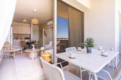 a dining room with a white table and chairs at Mystique 1-Bedroom Apartment in Larnaka