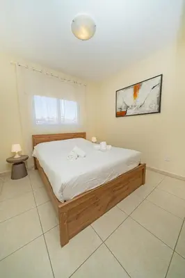 a bedroom with a large bed with white sheets at Modern 2 bedroom flat in Engomi in Strovolos