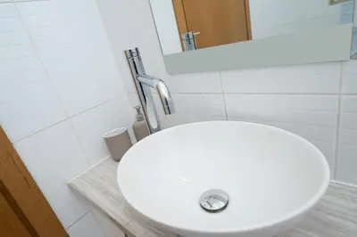 a white sink in a bathroom with a mirror at Modern 2 bedroom flat in Engomi in Strovolos