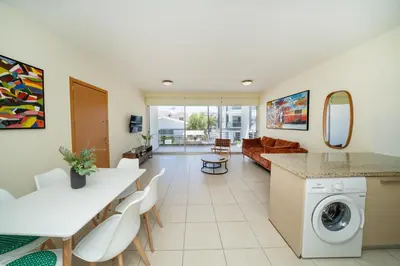 a kitchen and living room with a washer and dryer at Modern 2 bedroom flat in Engomi in Strovolos