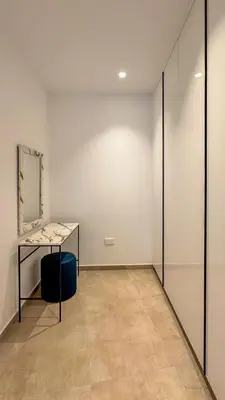an empty room with a mirror and a table at Aqua Beachfront Villas - Villa 1 in Ayia Napa