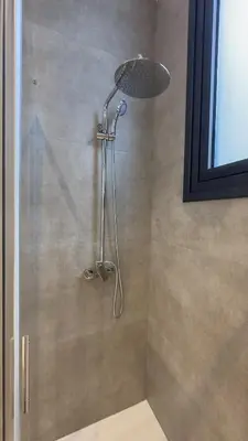 a shower with a shower head in a bathroom at Aqua Beachfront Villas - Villa 2 in Ayia Napa