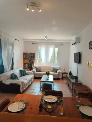 a living room with a couch and a table at Possidon Beach Getaway in Meneou