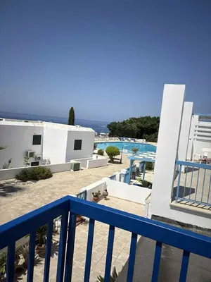 a view of a swimming pool from a balcony at Ikaria Village, Maisonette Sea 10 in Aglantzia