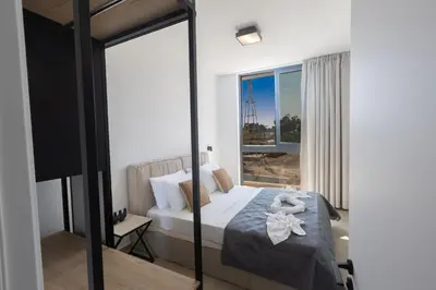 a bedroom with a bed and a large window at Orea Luxury Villas in Ayia Napa