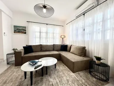 a living room with a couch and a table at STAY Cavo Bay Villa in Protaras