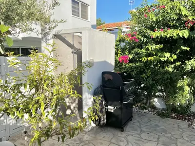a black trash can sitting next to a house at STAY Cavo Bay Villa in Protaras