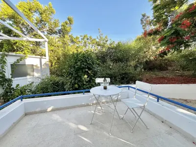 a white table and two chairs on a balcony at STAY Cavo Bay Villa in Protaras