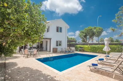 a villa with a swimming pool and a house at Mandali Villa in Protaras