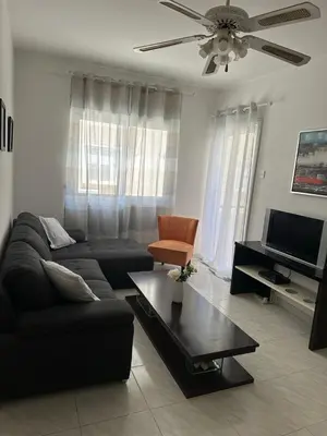 a living room with a couch and a table at Sunny house in Larnaka