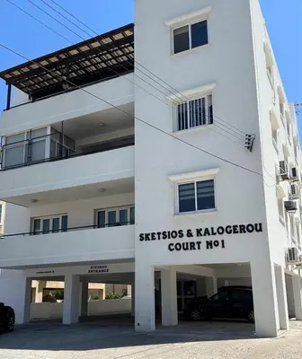 a white building with a sign on the side of it at Sunny house in Larnaka