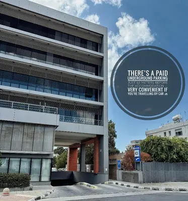 a building with a sign that reads there is a paid underground parkingvery convenient it at Urban Bay Limassol in Limassol