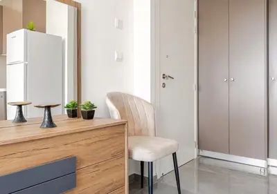 a kitchen with a desk with a chair and a refrigerator at Urban Bay Limassol in Limassol