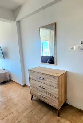 a dresser in a room with a mirror at Rita Seaview - Agios Tychonas Four Seasons Area in Limassol